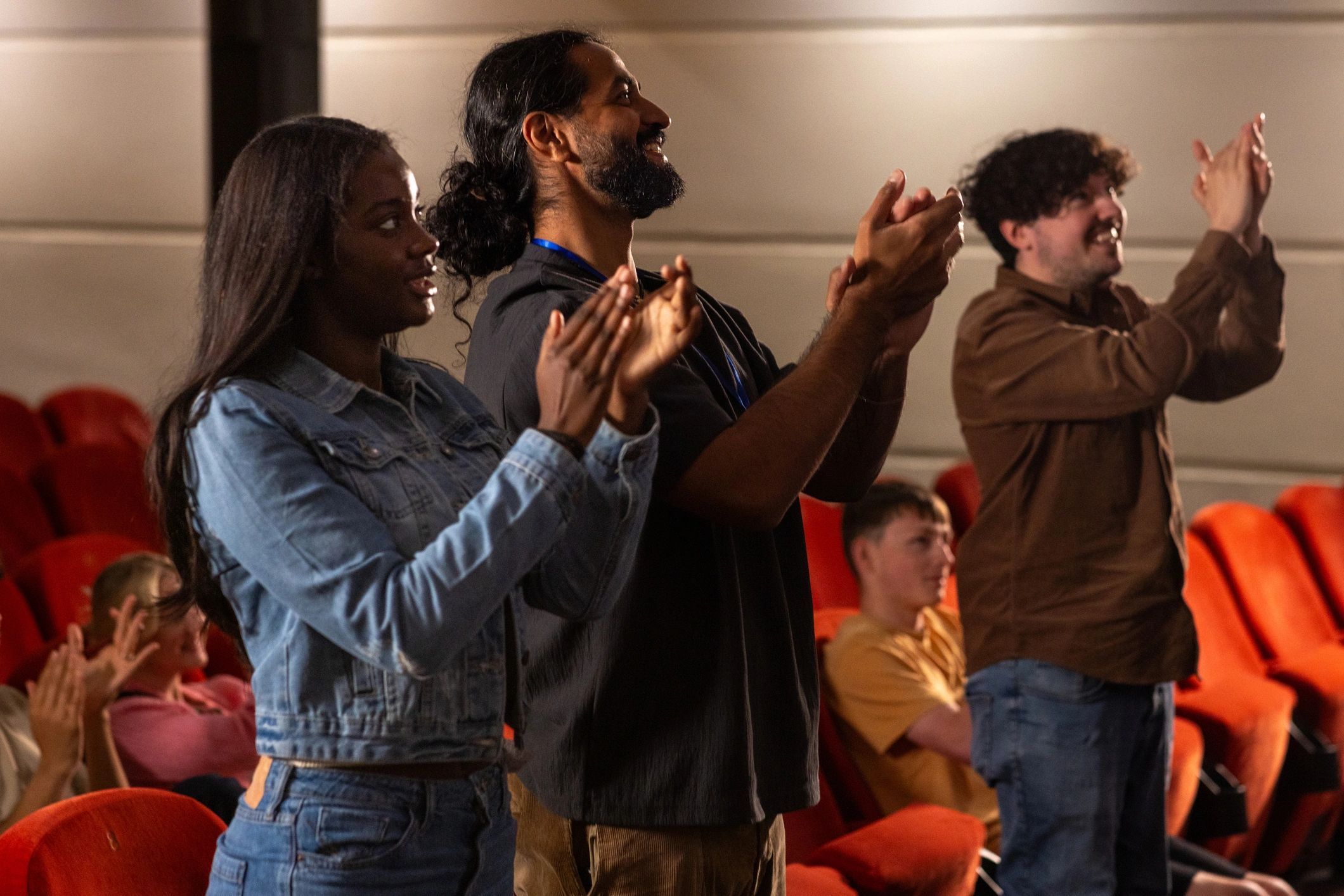 Audience members clapping together during an event